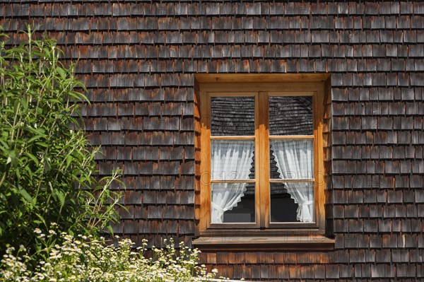 Wooden shingle facade with window at Hofrichterhaus near Seeon Monastery