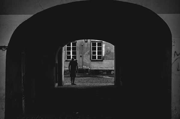 Man looking out of the yard gate