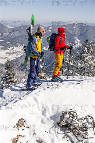 Young woman and man on ski tour