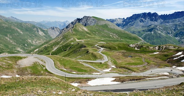 Sporty cyclists on alpine pass Col du Galibier