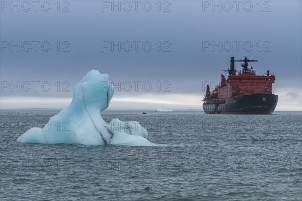 Icebreaker anchoring behind a iceberg