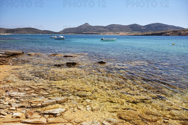 Golden shimmering beach in Antiparos with view of Despotiko