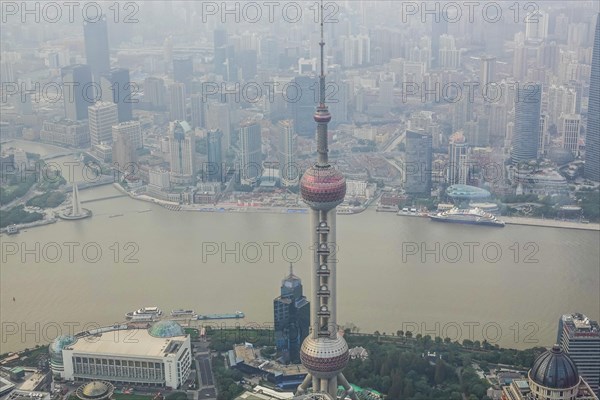 View from the highest observatory of the world on 562 meters height in the 632 meters high skyscraper Shanghai Tower on the special economic zone Pudong with the 468 meters high Oriental Pearl Tower the Huangpu River and the district Tilanqiao