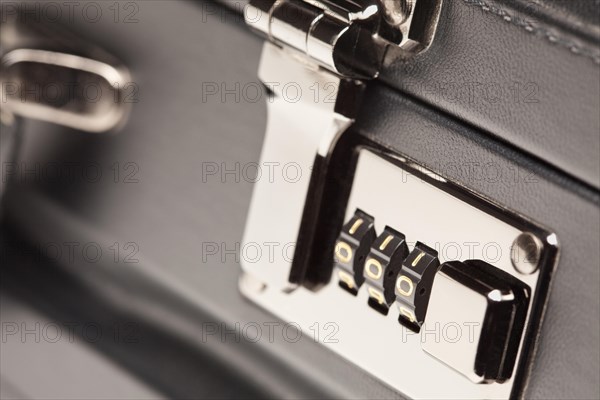 Abstract close up shot of a black leather briefcase latch and lock