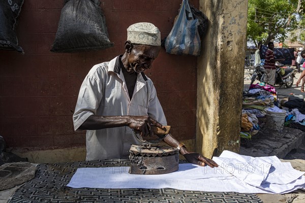 Many ironing with very old iron