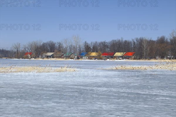 Colourful cottages on the frozen Saint Lawrence River