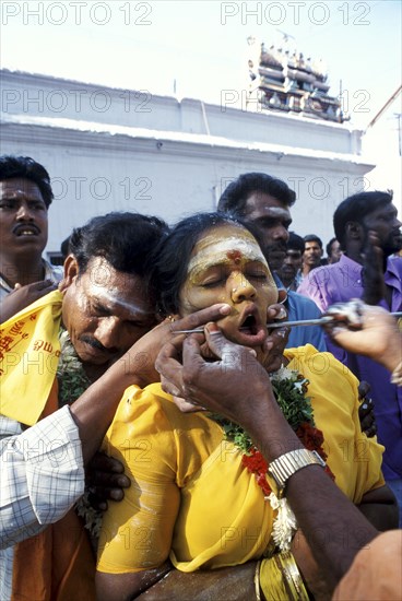 Priest pierces a womans face with a spear