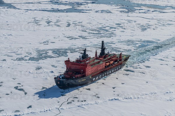 Aerial of the Icebreaker '50 years of victory' on its way to the North Pole breaking through the ice