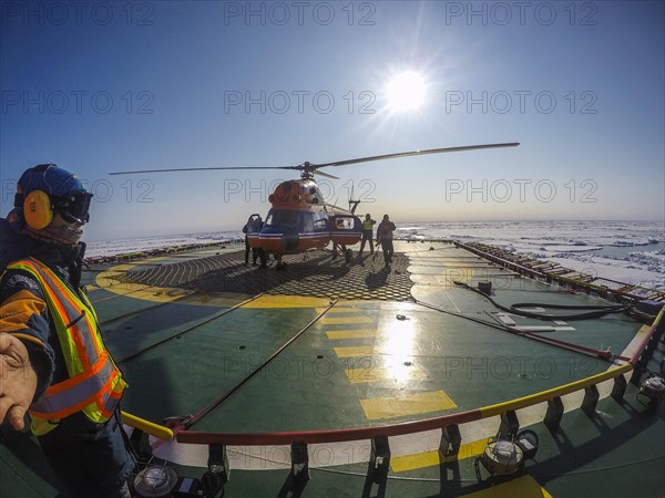 Helicopter on the Helipad of the Icebreaker '50 years of victory' on its way to the North Pole breaking through the ice