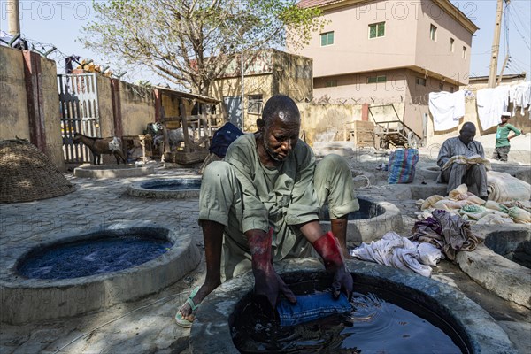 Man dyeing cllothes with Indigo