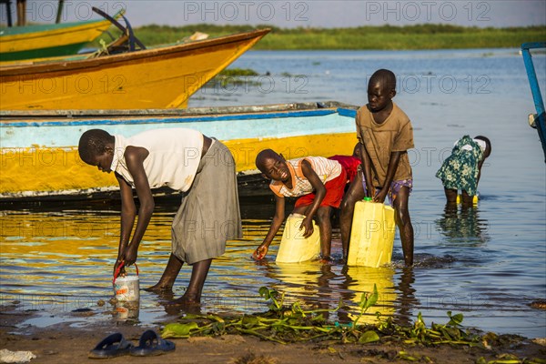 Children filling water in canisters at Lake Albert