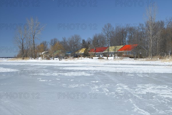 Colourful cottages along the frozen Saint Lawrence River