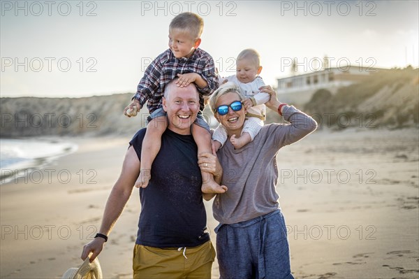 The family with two small boys enjoying the beach