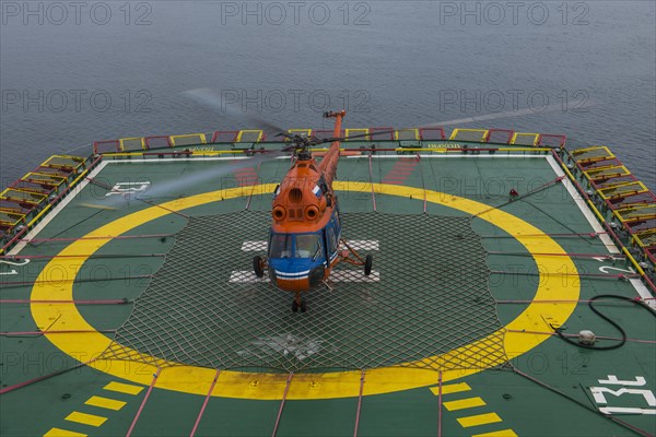 Helicopter landing on a helipad of an icebreaker