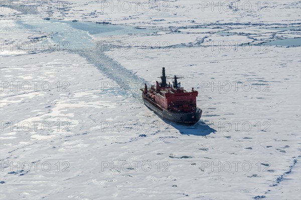 Aerial of the Icebreaker '50 years of victory' on its way to the North Pole breaking through the ice