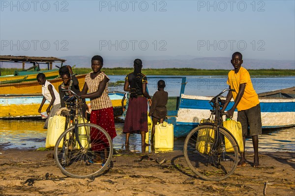 Children filling water in canisters at Lake Albert