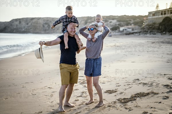 The family with two small boys enjoying the beach