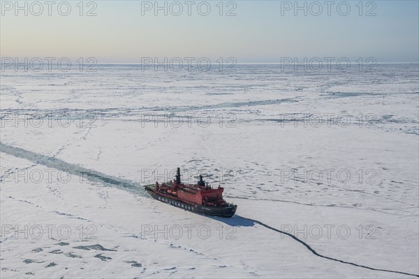 Aerial of the Icebreaker '50 years of victory' on its way to the North Pole breaking through the ice