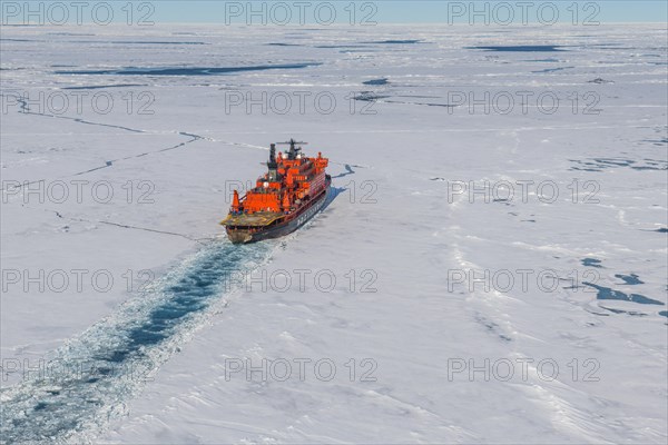 Aerial of the Icebreaker '50 years of victory' on its way to the North Pole breaking through the ice