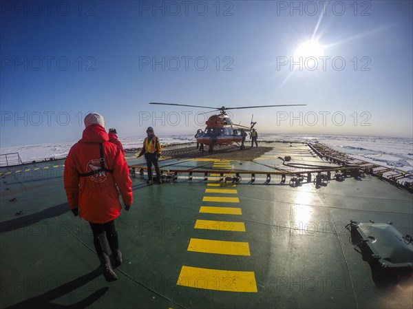 Helicopter on the Helipad of the Icebreaker '50 years of victory' on its way to the North Pole breaking through the ice