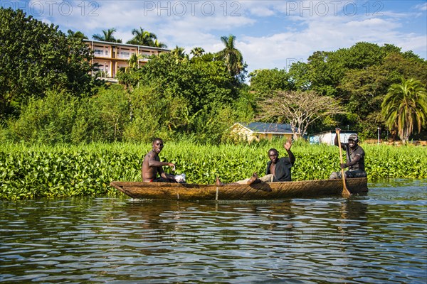 Local fisherman in a dugout canoe in Jinja