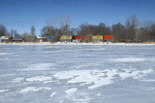 Colourful cottages along the frozen Saint Lawrence River