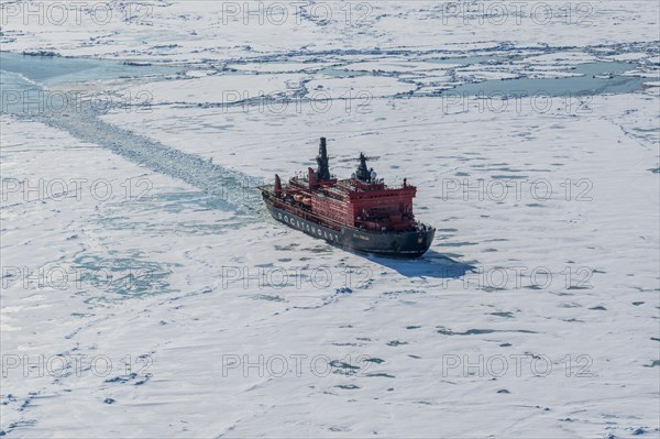 Aerial of the Icebreaker '50 years of victory' on its way to the North Pole breaking through the ice