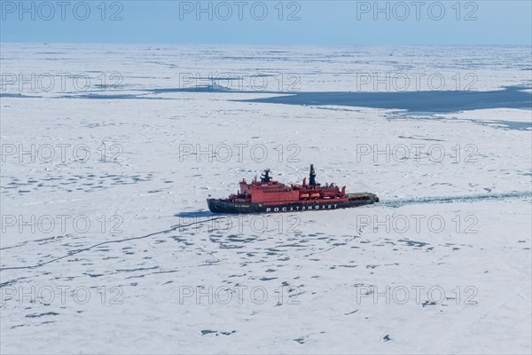 Aerial of the Icebreaker '50 years of victory' on its way to the North Pole breaking through the ice