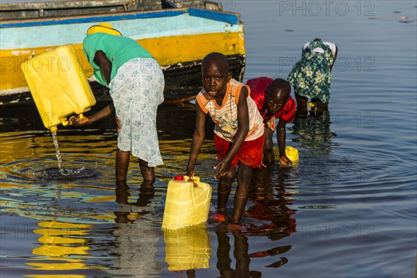 Children filling water in canisters at Lake Albert