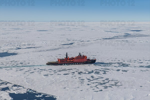 Aerial of the Icebreaker '50 years of victory' on its way to the North Pole breaking through the ice