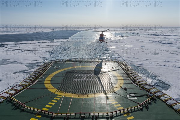 Helicopter on the Helipad of the Icebreaker '50 years of victory' on its way to the North Pole breaking through the ice