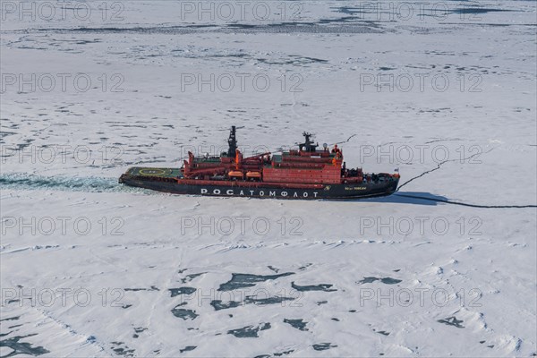 Aerial of the Icebreaker '50 years of victory' on its way to the North Pole breaking through the ice