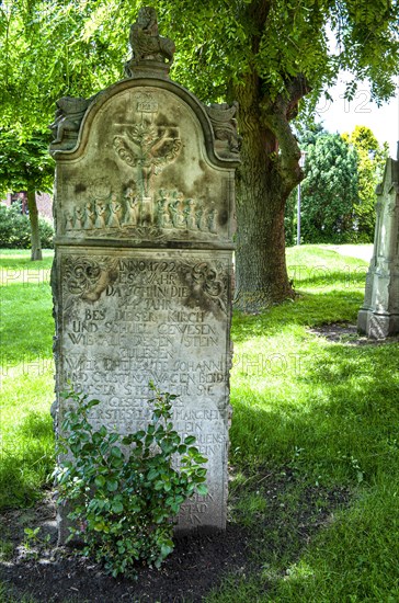 Historic sandstone gravestone from the 18th century in the churchyard of St. Nicholas Church