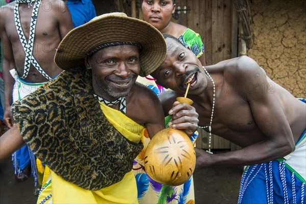 Friendly men drinkin local beer on a Ceremony of former poachers