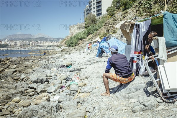 Tents and self-constructed huts on the cliff