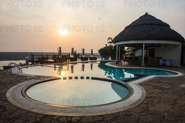 Swimming pool above the Kazinga channel linking lake george and lake Edward at sunset