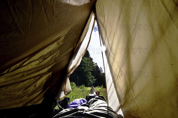 Legs peeping out of tent