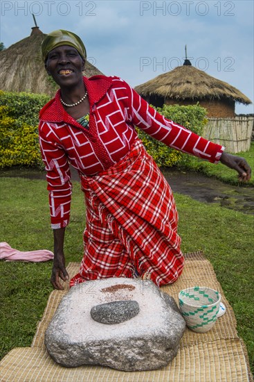 Woman preparing local bread at a ceremony of former poachers