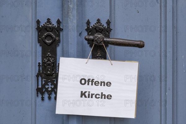 Open Church sign on the portal of the Protestant Church of St. Johannis in Luechow