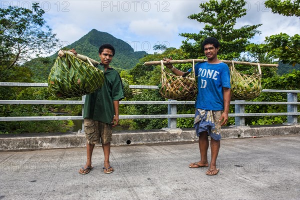 Local farmers bringing their goods in palm baskets back home