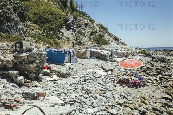 Tents and self-constructed huts on the cliff at the coastal section El Sarchal