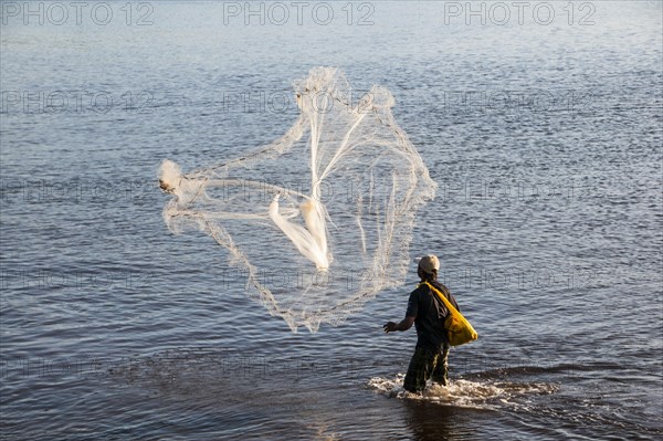 Man netfishing in the harbour of Apia