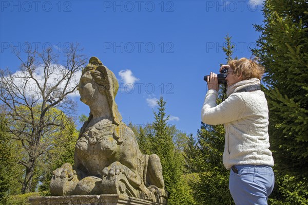 Woman photographing Sphinx statue