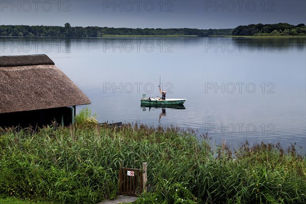 Angler with boat in the Schaalsee