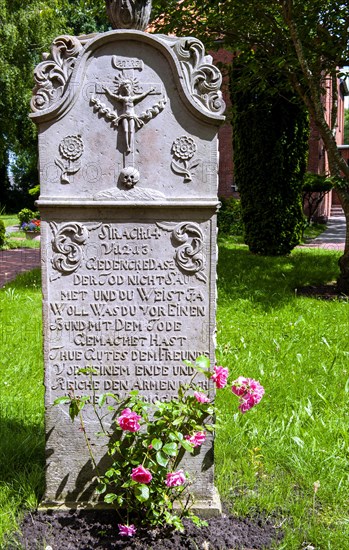 Historic sandstone gravestone from the 18th century in the churchyard of St. Nicholas Church