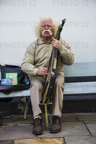 Man playing the traditional Bandura instrument