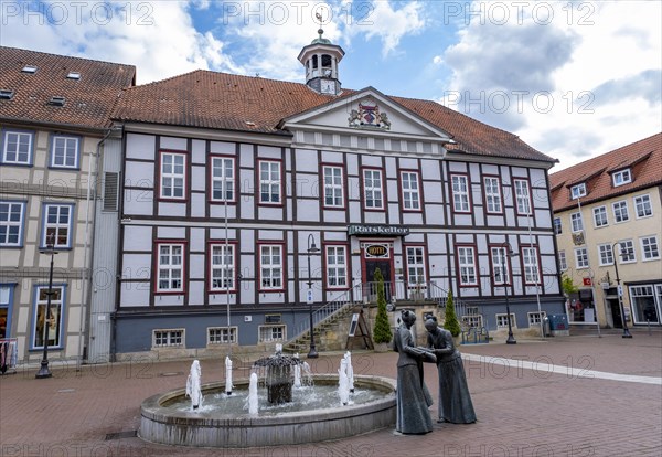 Sculpture of two linen weavers at the fountain in front of the town hall in Luechow