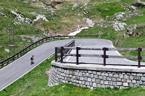 Road cyclist on the south side of the Spluegen Pass