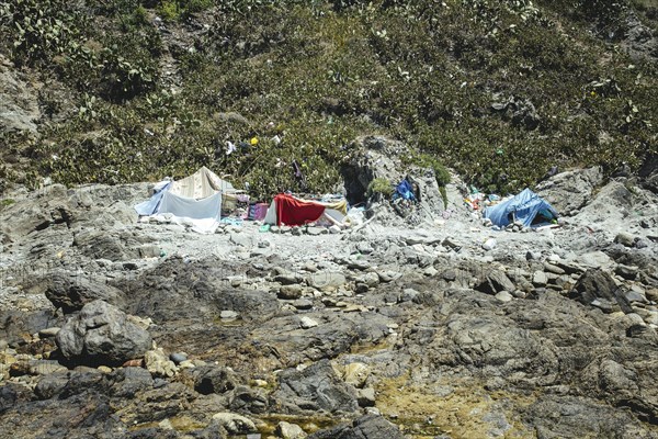 Tents and self-constructed huts on the cliff