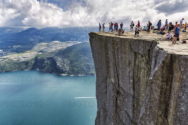 Hiker on rocky peak Preikestolen